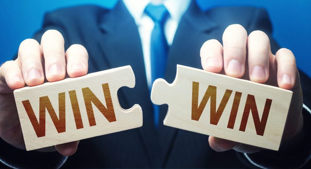 person in a suit with a puzzle that says win win